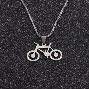Polished titanium steel bicycle pendant necklace on a sparkling black background