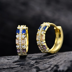 Golden S925 silver hoop earrings with multi-color cubic zirconia on grey texture