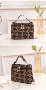 Detail of clover diamond print handbag with double zippers and gold chain strap