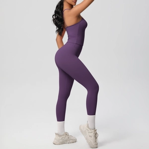 Side view of dark purple seamless yoga set showing high-waist leggings and cropped tank top