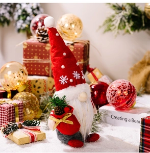 Detail of Christmas gnome plush with red pearled hat and pine cone in festive setting
