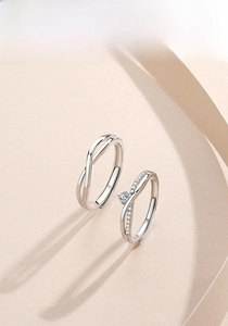 Close-up of S925 sterling silver Mobius couple rings with sparkling pavé set diamonds