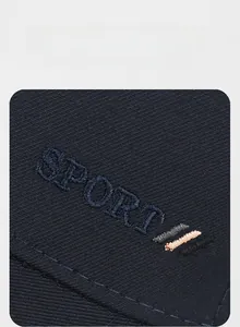 Macro shot of high-quality navy twill fabric with 3D SPORT embroidery on the baseball cap