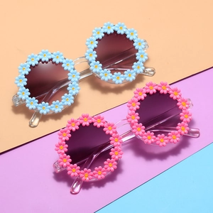 Sunflower shaped kids sunglasses in light blue and pink frames with round daisy design