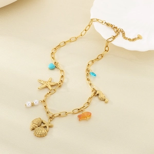 Gold bohemian ocean theme necklace featuring starfish, seashells, and turquoise beads