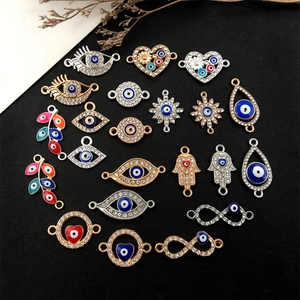 Variety of Evil Eye pendants in gold and silver with heart, leaf, and palm shapes