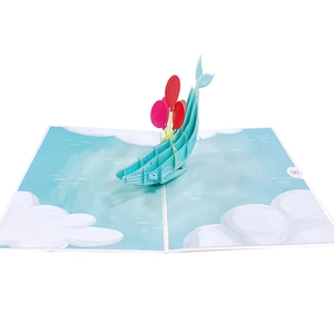 Detailed 3D pop-up card featuring a blue whale with colorful balloons over ocean waves