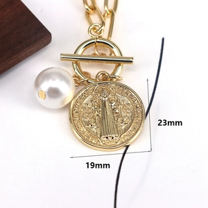 Vintage religious gold medallion necklace with white pearl pendant and toggle clasp