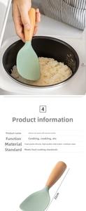 Detail of mint green heat-resistant silicone rice paddle with natural wood handle