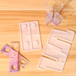 Detailed view of clear silicone molds and resin test tube vase components on wood
