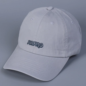 Detailed view of the Surfing embroidery on a light blue-grey cotton baseball cap
