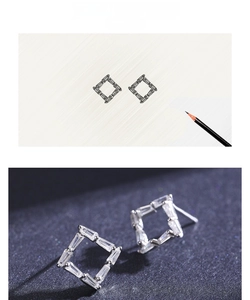 Macro view of geometric hollow square earrings with baguette zircons and design sketches