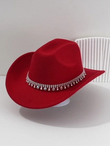 Close-up of red felt cowboy hat featuring silver beads and sparkling rhinestone band