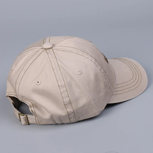 Detail of adjustable metal buckle and stitching on khaki cotton baseball cap