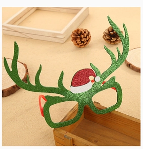 Detail of green sequin reindeer glasses with a small red Santa hat for Christmas parties