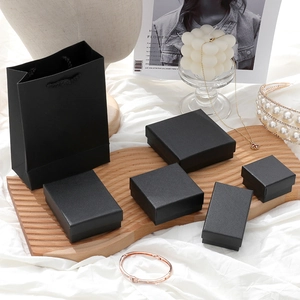 Detail of elegant black jewelry box set and paper bag in a lifestyle setting