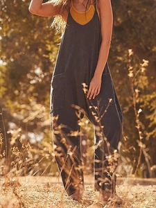 Outdoor shot of loose dark grey cotton linen overalls with yellow tank top camisole