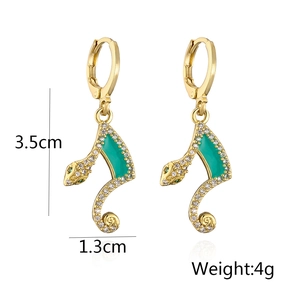 Detail shot of 18K gold plated snake earrings with green enamel, zircons and dimensions