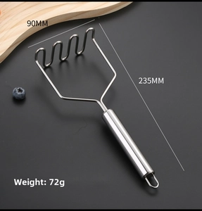 Detail of stainless steel potato masher with wavy head and hanging loop on dark background