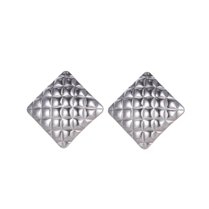 Macro shot of silver square stud earrings featuring a classic quilted metal texture
