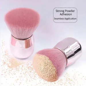 Pink mushroom makeup brush with rose gold handle for loose powder and blush application