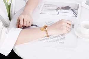 Golden heart pendant bracelet with OT clasp on model wrist, size 18cm length