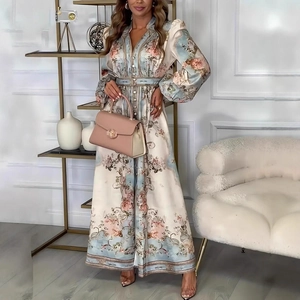 Detailed view of elegant floral maxi dress featuring waist tie and button-up puff sleeves