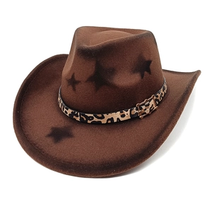 Close-up of brown felt cowboy hat with leopard print band and black star patterns
