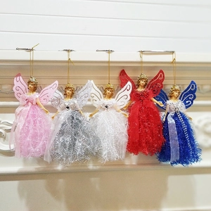Colorful lace angel doll ornaments with glitter wings hanging on a white fireplace