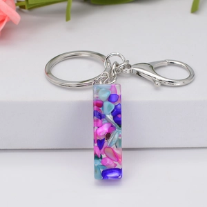 Detail of resin keychain pendant with colorful stones, silver lobster clasp and keyring