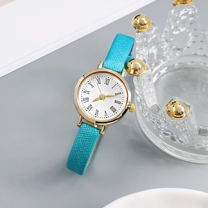 Detail of vintage ladies watch with turquoise leather strap and gold case on crown stand