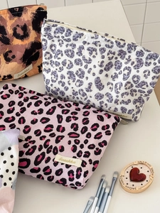 Detailed close-up of high-capacity leopard print makeup bags with zipper closure