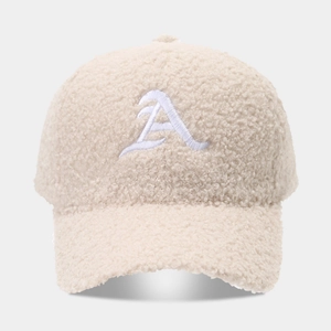 Detailed view of beige sherpa fleece baseball cap with white embroidered letter A
