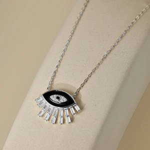 Macro detail of S925 sterling silver evil eye pendant with zircon and black enamel