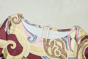 Close-up of the round neckline and concealed back zipper on the printed long sleeve jumpsuit