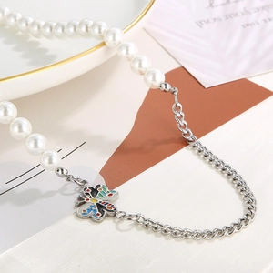 Detailed shot of titanium steel necklace with pearls and a colorful butterfly pendant