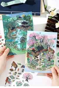 Détail de cartes autocollantes rétro tenues à la main avec illustrations de cerisiers