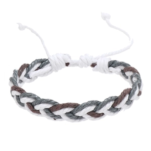 Detailed shot of handmade braided cord bracelet with adjustable knot in white, grey, and brown