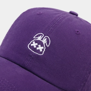 Close-up of white rabbit embroidery on purple cotton twill baseball cap fabric