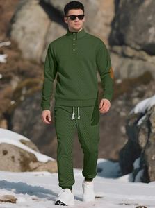 Detail of men's green knit tracksuit featuring stand collar with button and elbow patches