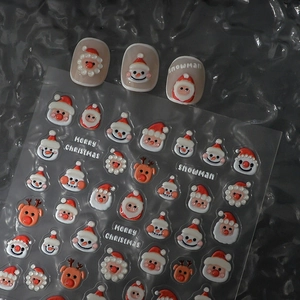 3D Christmas nail stickers featuring Santa Claus and snowman patterns on dark background