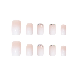 Pink and white gradient press-on nails with colorful rhinestones in a square shape