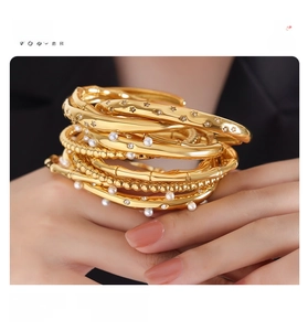 Close-up of 18k gold plated titanium bracelet with pearls and bamboo texture detail