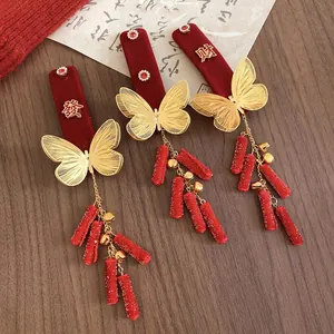 Three-piece set of red velvet butterfly hair clips with golden bells for New Year