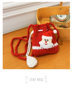 Detail of red crochet Christmas bag with a 3D Santa Claus figure and drawstring