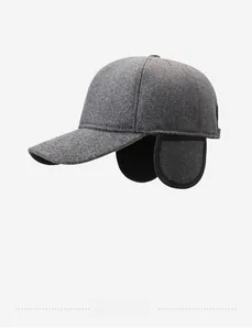 Close-up of dark grey thermal ear flap hat with wool texture and silver metal logo