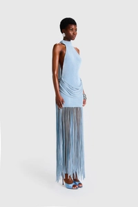 Detail of light blue halter dress with backless cut and long tassel fringe hemline