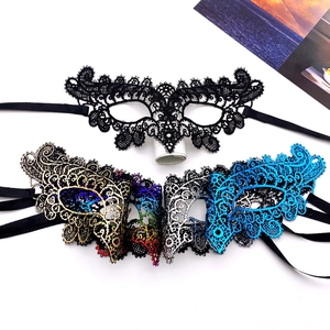Detailed texture of lace masquerade masks with gold stamping and satin ribbons