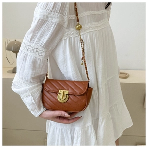 Detail of brown V-quilted PU leather crossbody bag with retro metal buckle and gold chain