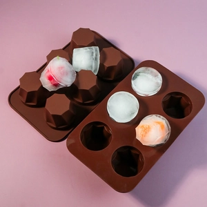 Detail showing 6-cavity brown silicone mold with fruit-infused ice cubes inside